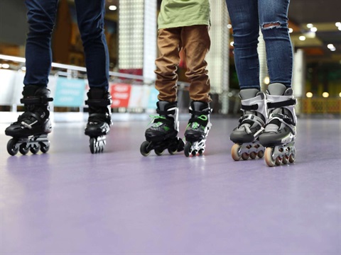 People wearing roller skates on a roller rink